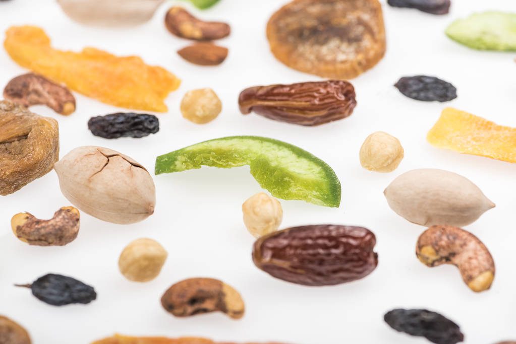 close up view of tasty assorted nuts, dried fruits and candied fruit isolated on white - Photo, Image