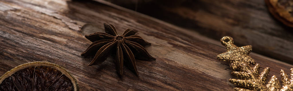 dried citrus slice with anise and decorative snowflake on wooden background, panoramic shot - Photo, Image