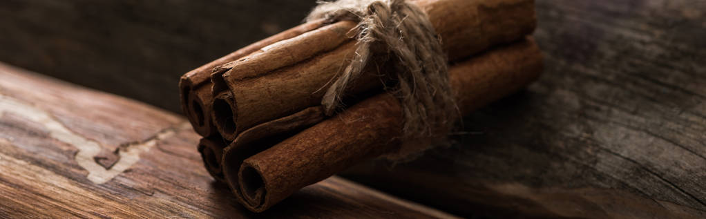 close up view of cinnamon sticks on wooden background, panoramic shot - Photo, Image