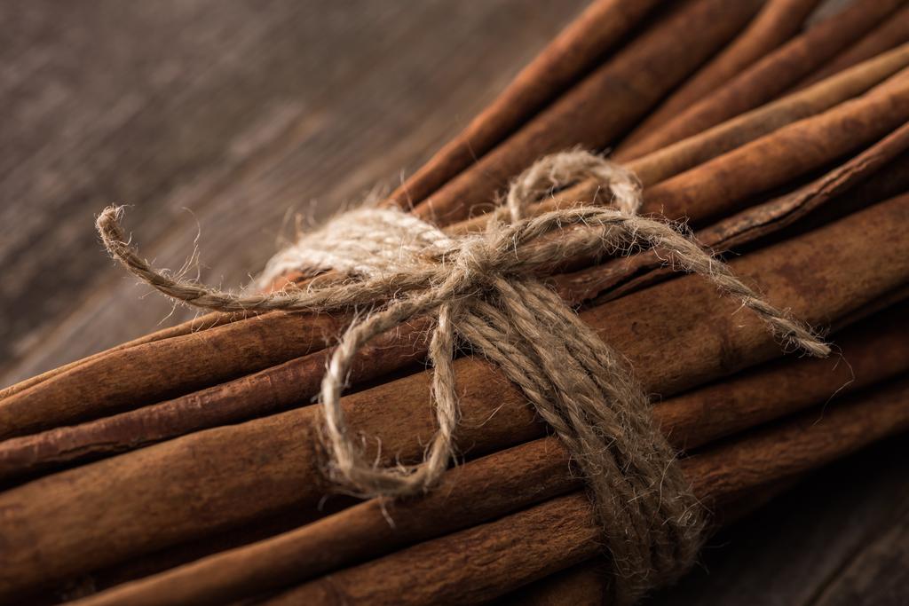 close up view of cinnamon sticks in bunch on wooden rustic table - Photo, Image