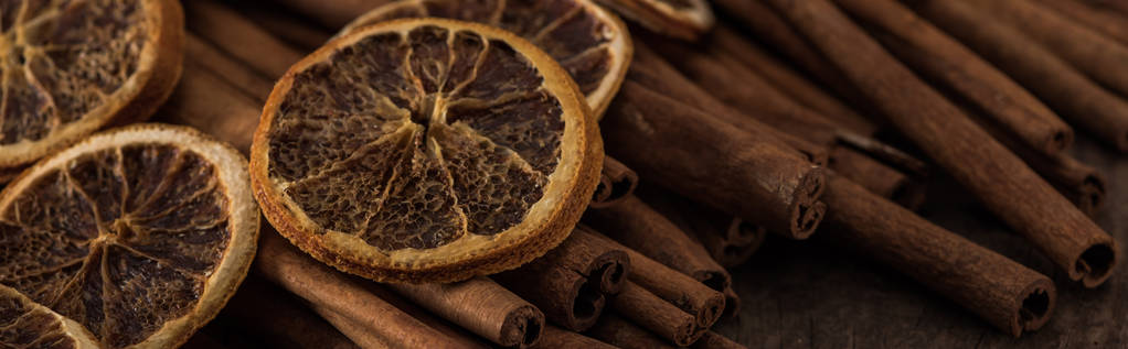 close up view of dried orange slices and cinnamon, panoramic shot - Photo, Image
