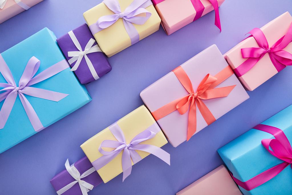plano con coloridos regalos con arcos sobre fondo púrpura
 - Foto, Imagen