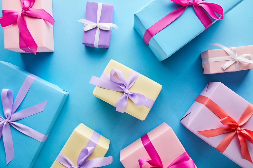 top view of colorful gift boxes on blue background - Photo, Image