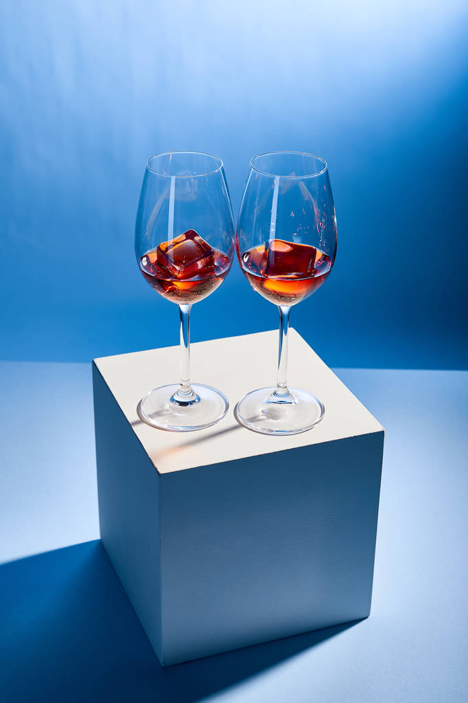 cocktails Aperol Spritz with ice cubes in glasses on blue background  - Photo, Image