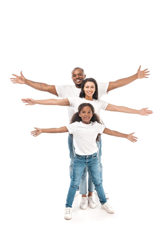 cheerful african american kid with parents imitating flying with outstretched hands on white background - Photo, Image