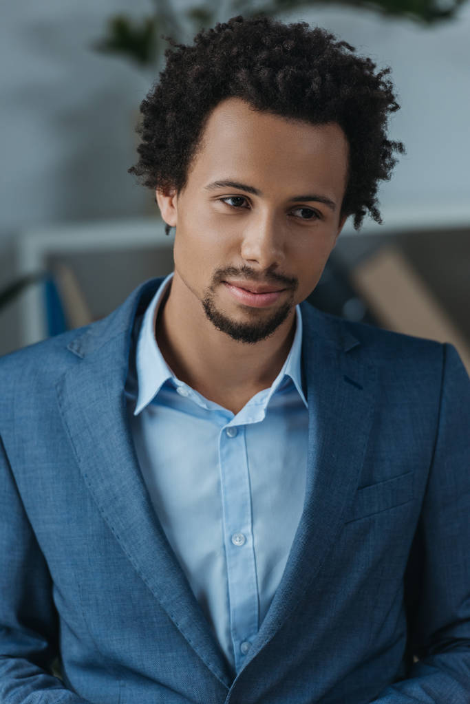 young, thoughtful african american businessman in office - 写真・画像