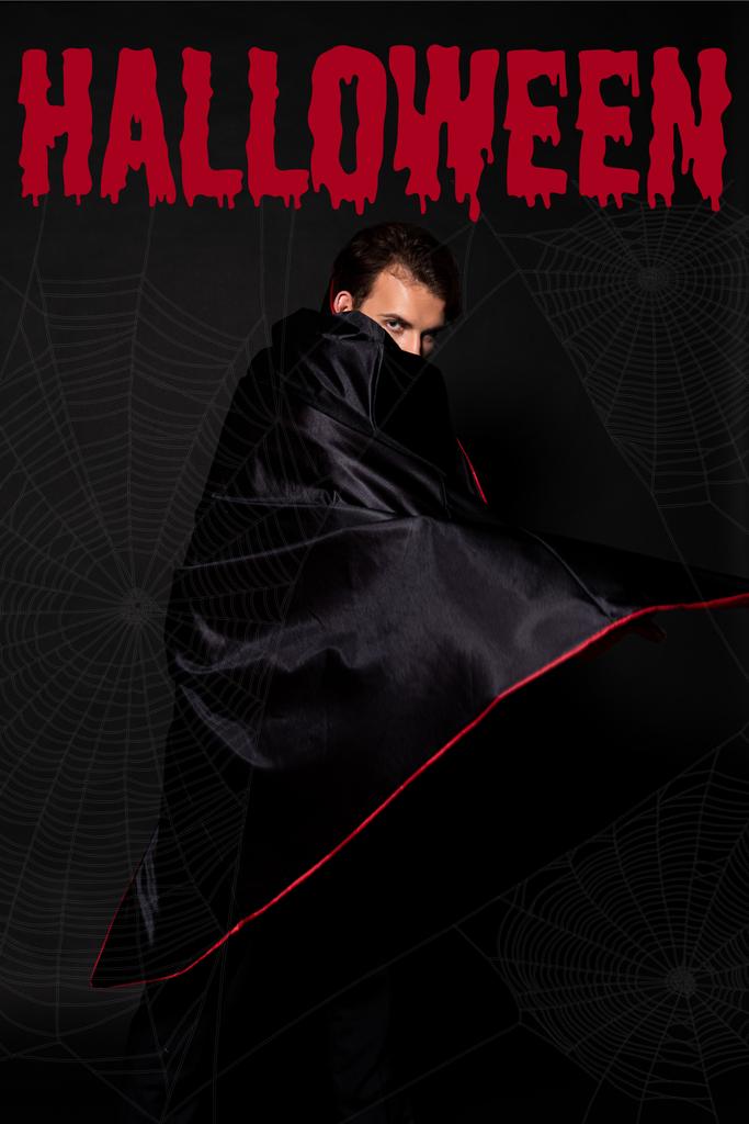 man covering face with cloak on black background with Halloween bloody illustration - Photo, Image