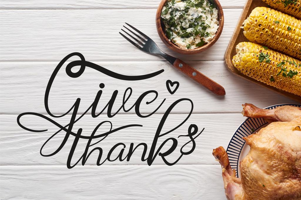 top view of turkey and corn served at white wooden table with give thanks illustration - Photo, Image