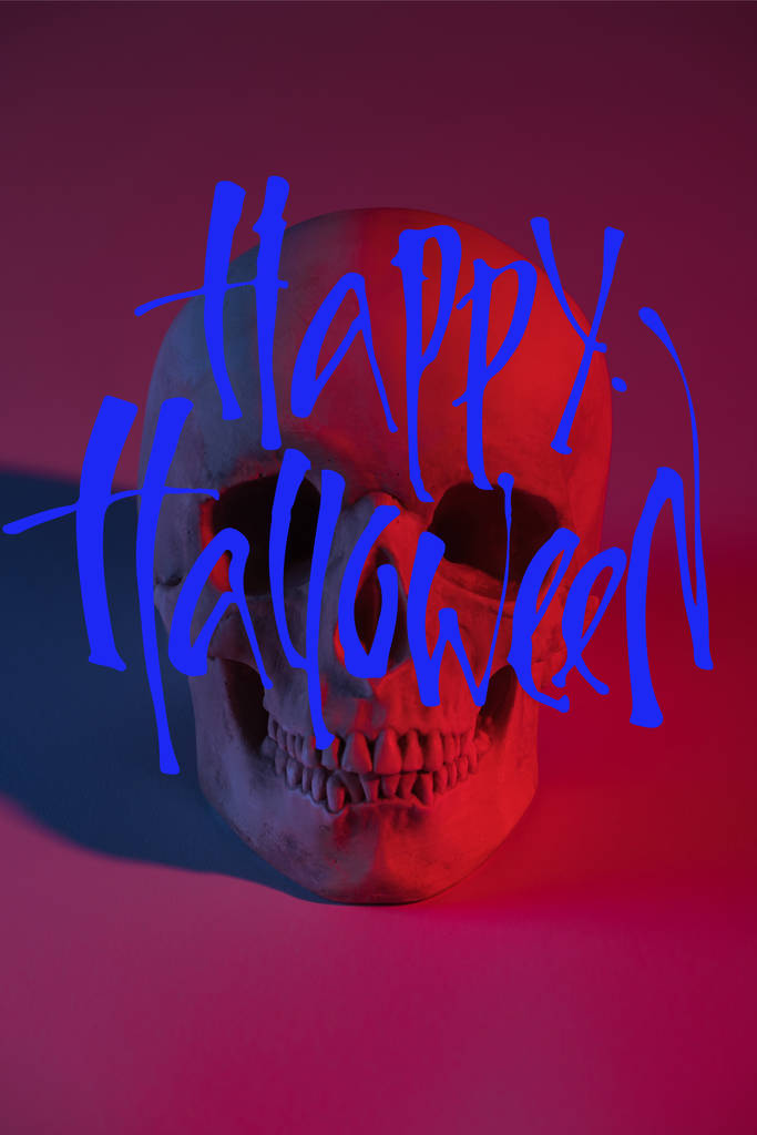 Gruseliger menschlicher Totenkopf in rotem Licht, Halloween-Dekoration mit fröhlicher Halloween-Illustration - Foto, Bild