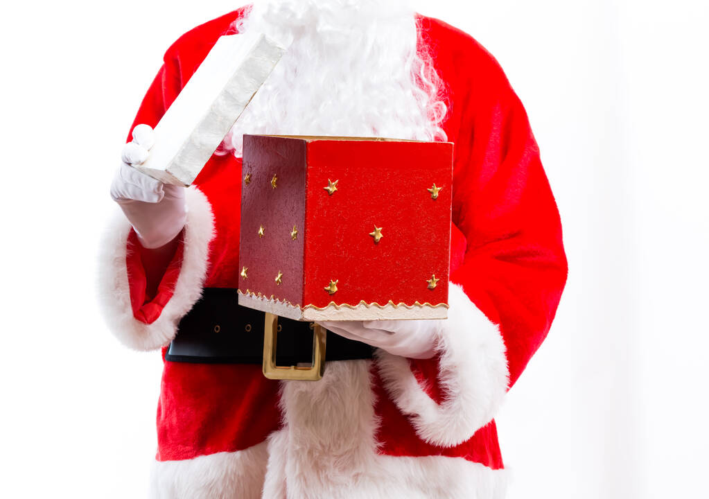 Santa abre una caja de regalo
 - Foto, imagen