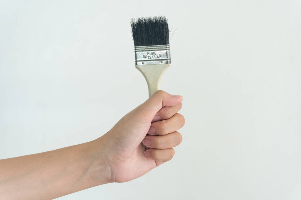 Hand holding Brush on white background - Photo, Image