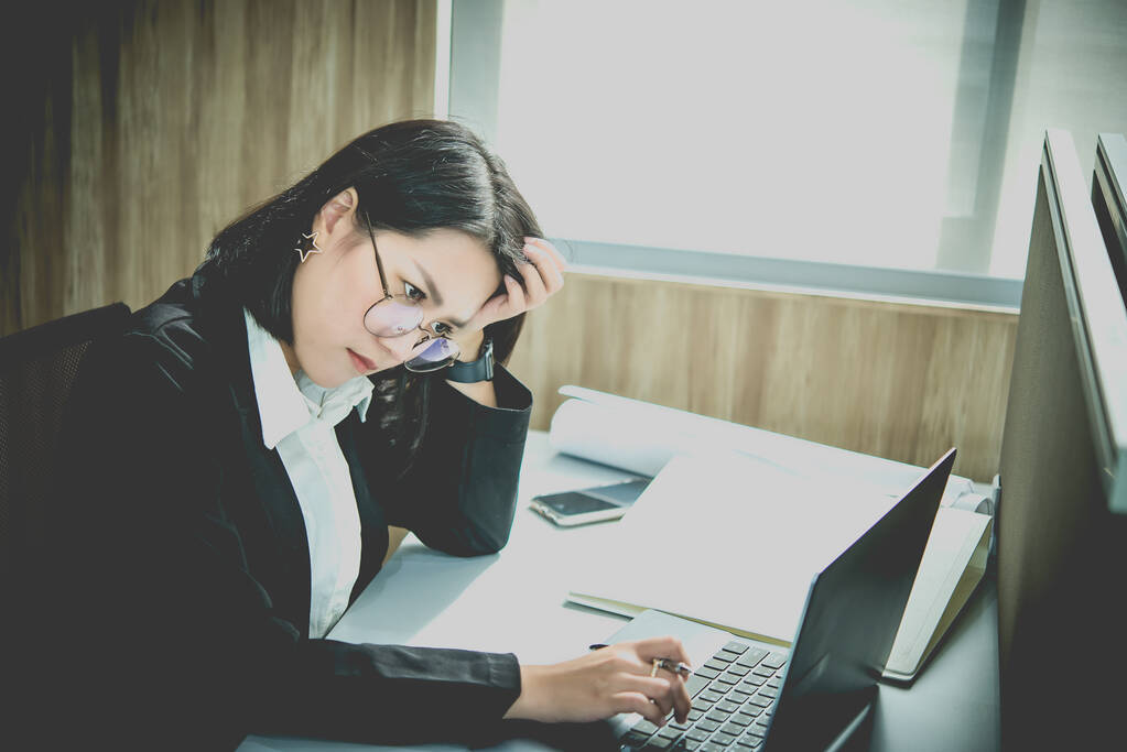 Asian woman working in office,young business woman stressed from work overload with a lot file on the desk,Thailand people thinking something - Photo, Image