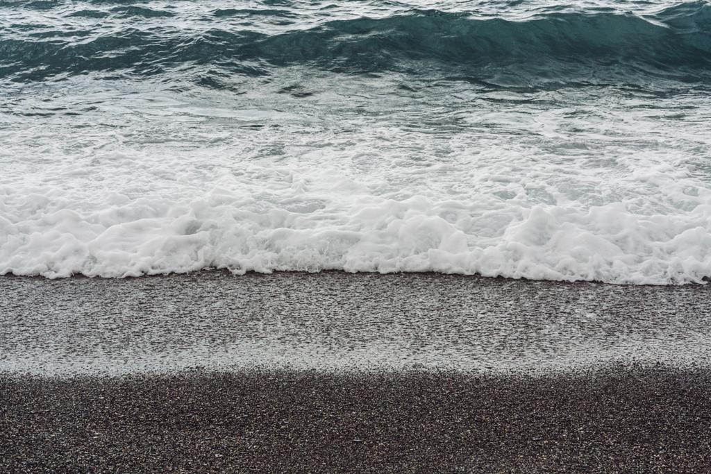 sea waves splash on sandy beach in summer  - Photo, Image