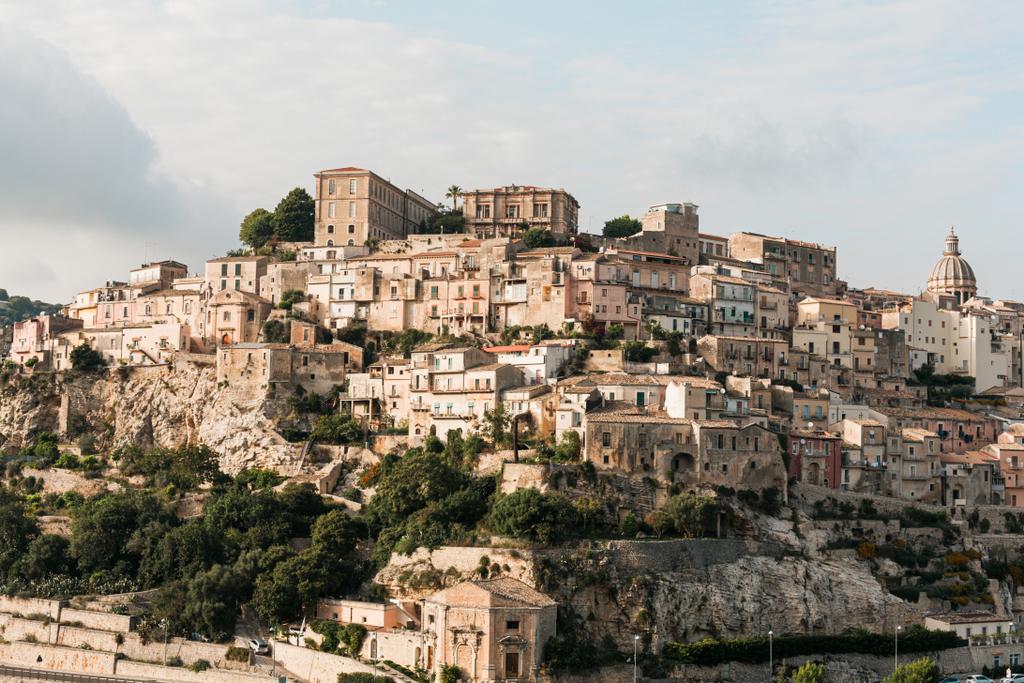 sunshine on trees near small houses in ragusa, italy  - Photo, Image