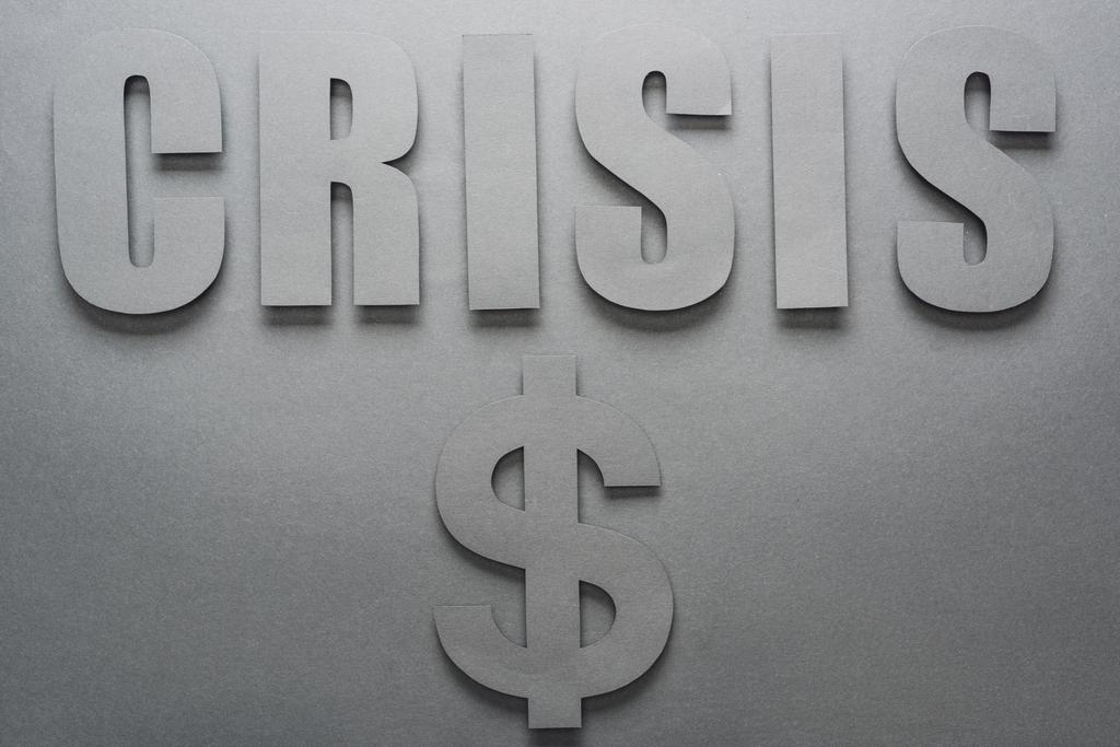 top view of word crisis and dollar sign on grey background with shadows - Photo, Image