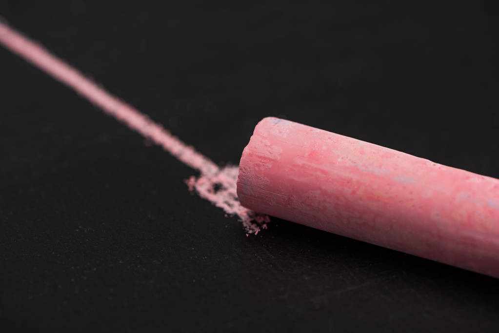 close up view of pink chalk on black surface with drawn line, connection concept - Photo, Image