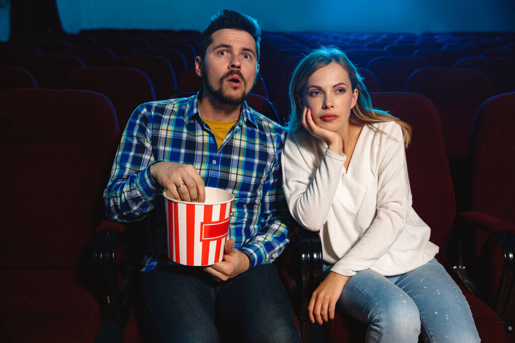 Attractive young caucasian couple watching a film at a movie theater - Photo, Image