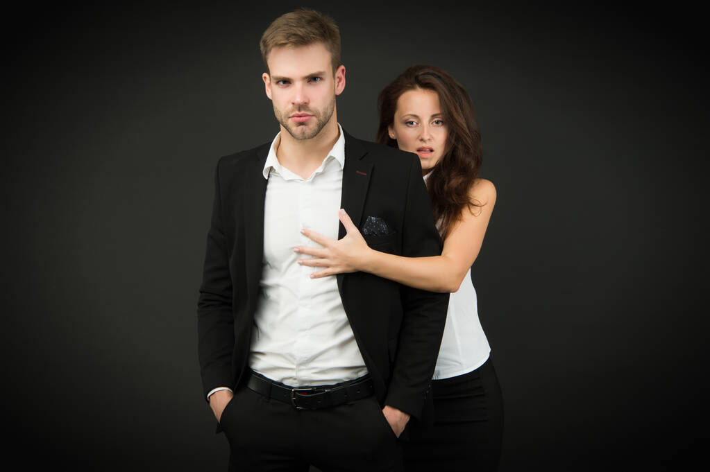Turning your passion into business. Couple of business partners. Working couple on dark background. Couple in love in formal wear. Romantic couple of handsome man and sensual woman - Photo, Image