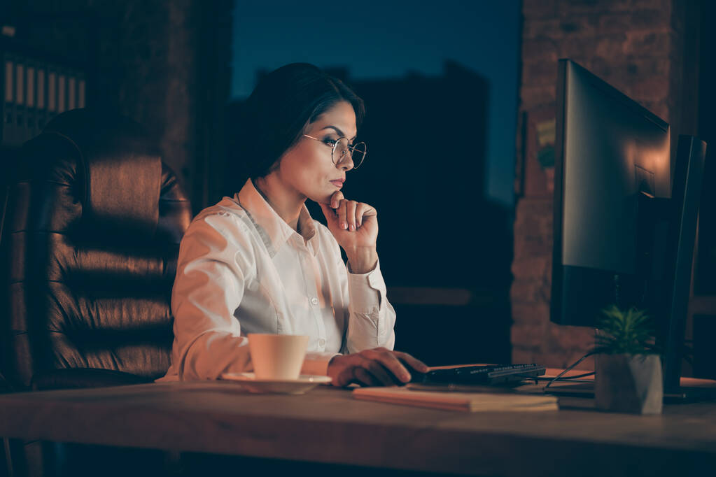 Profile side view portrait of her she nice attractive focused lady economist auditor attorney lawyer top manager company owner marking analysis deadline at night dark work place station indoors - 写真・画像