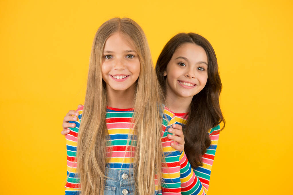 Children are the future. Happy children with long hair yellow background. Small children in casual style. Little children cute smiling. International childrens day - Photo, Image