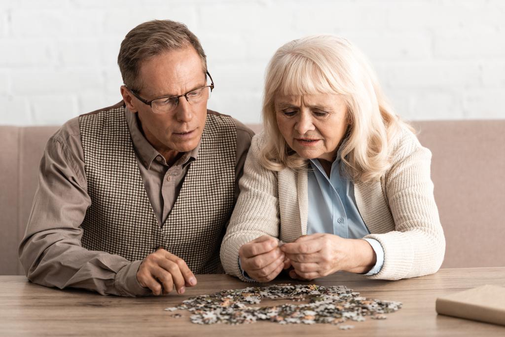 selective focus of senior couple with mental illness matching puzzle pieces - Photo, Image