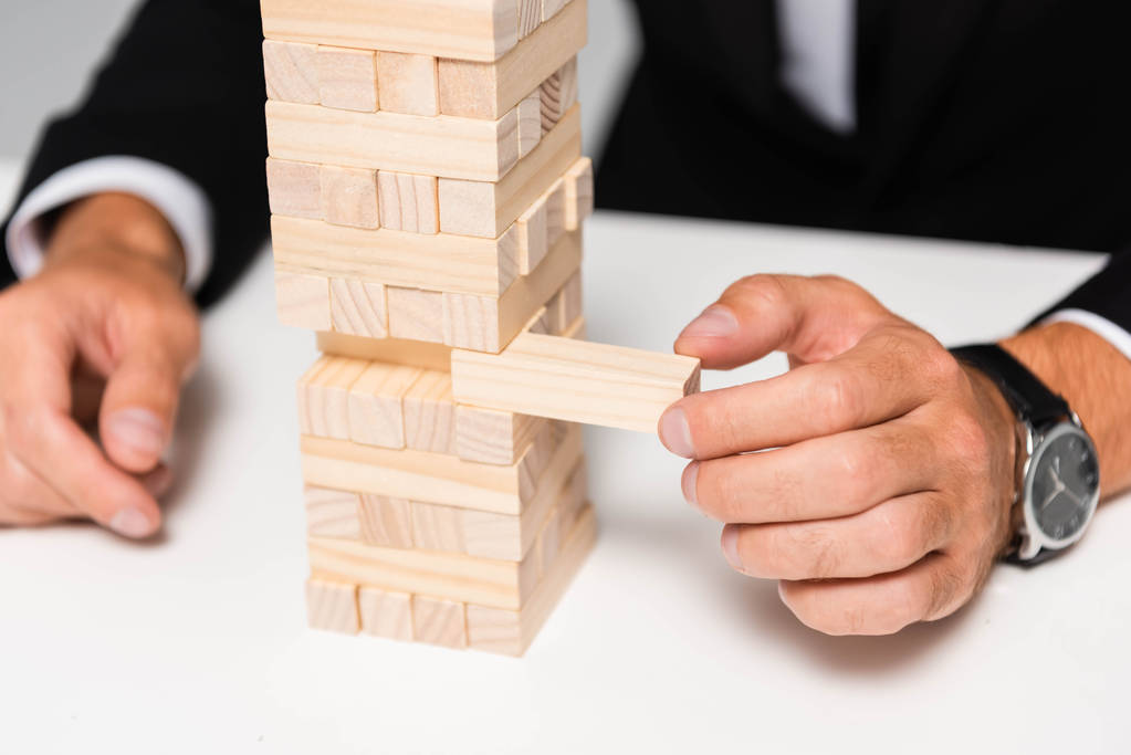 cropped view of businessman in suit playing blocks wood game  - 写真・画像