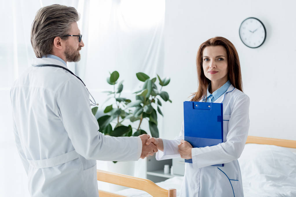 médecin en manteau blanc et son collègue serrant la main à l'hôpital
  - Photo, image