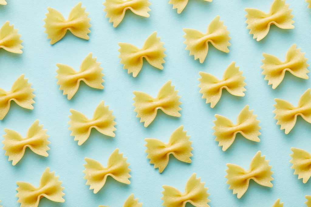 flat lay with raw Farfalle on blue background - Photo, Image