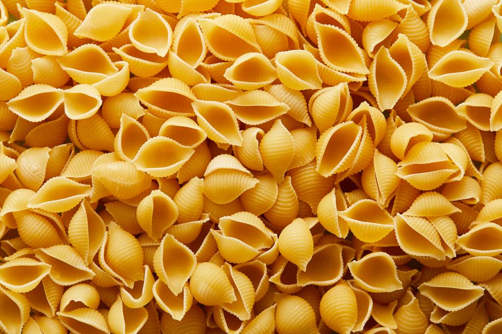 top view of raw Conchiglie seamless background - 写真・画像
