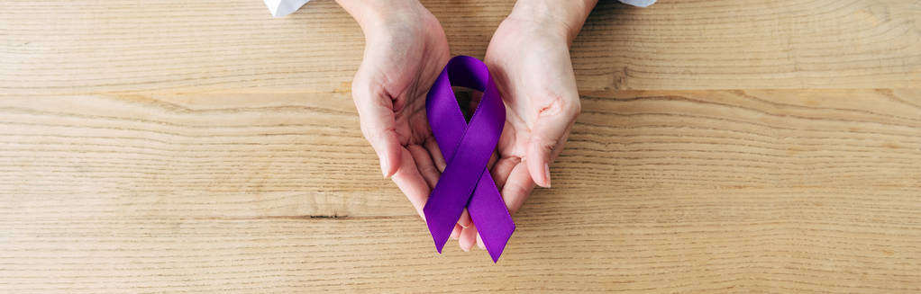 panoramic shot of doctor holding purple ribbon in clinic  - Photo, Image