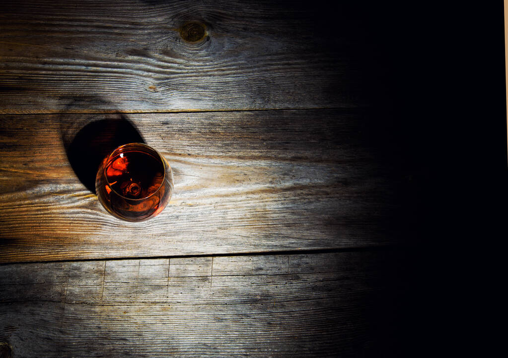 glass with cognac on a wooden background - Photo, Image