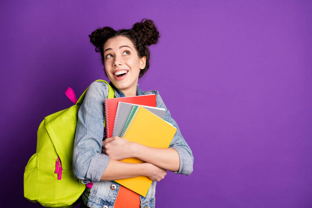 Portrait of cute sweet high-school girl feel funny funky hold note books inspired wait lessons lectures wear casual style outfit isolated over purple color background - 写真・画像