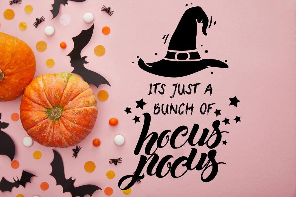 top view of pumpkin, bats and confetti on pink background with its just a bunch of hocus pocus illustration - Photo, Image