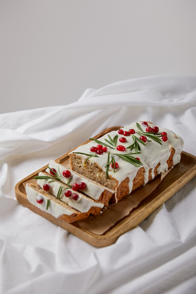 traditional Christmas cake with cranberry on wooden board on white cloth isolated on grey - Photo, Image