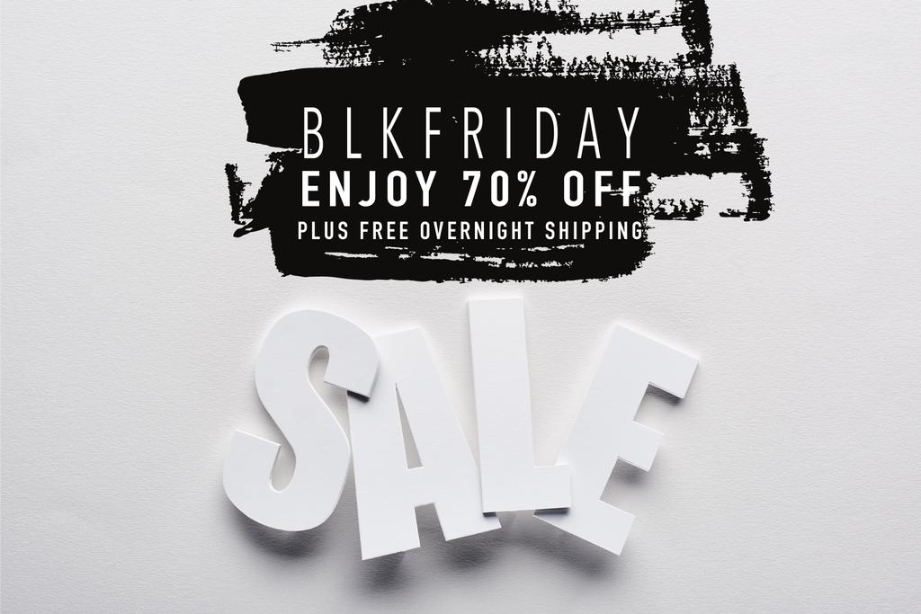 top view of white sale lettering on white background with black Friday, 70 percent off illustration - Photo, Image