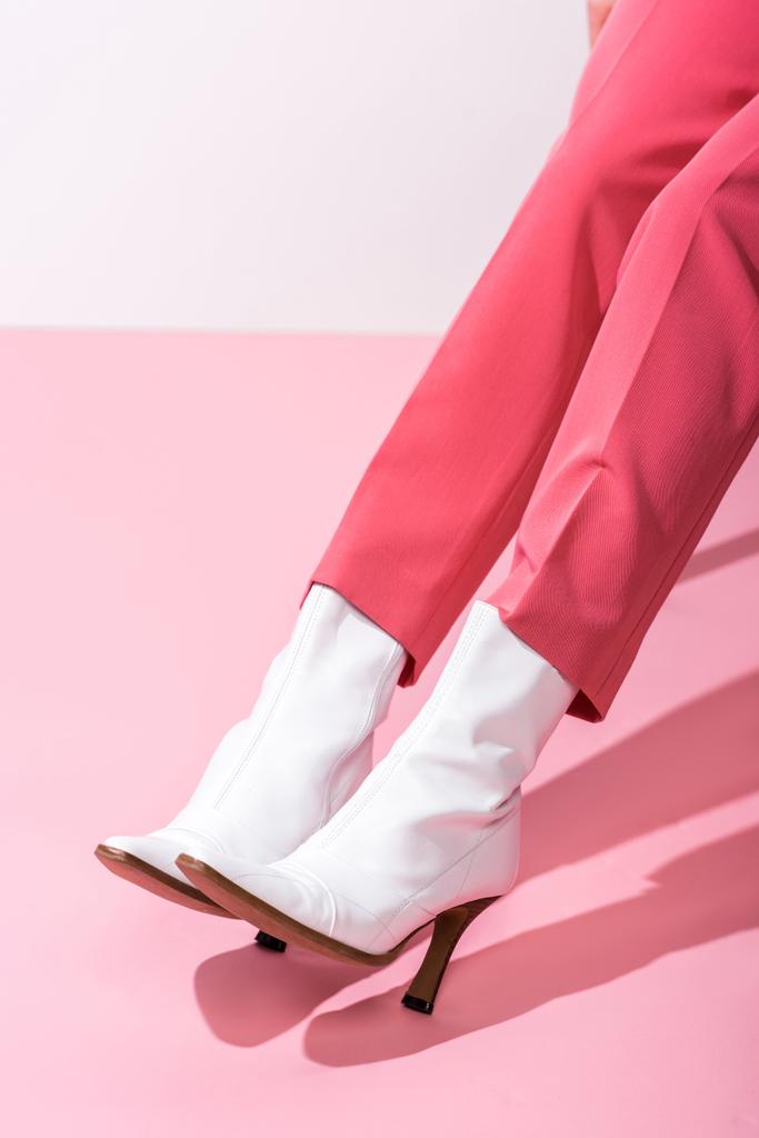 cropped view of girl in boots on white and pink  - Photo, Image