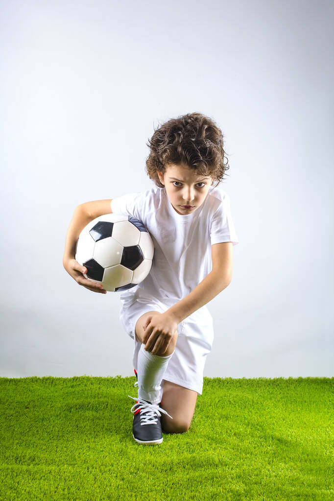 Summer soccer tournament for young kids. football club. emotions and joy of the game. Kids - soccer champion. Boy in football sportswear in the studio. Sport concept. - Photo, Image