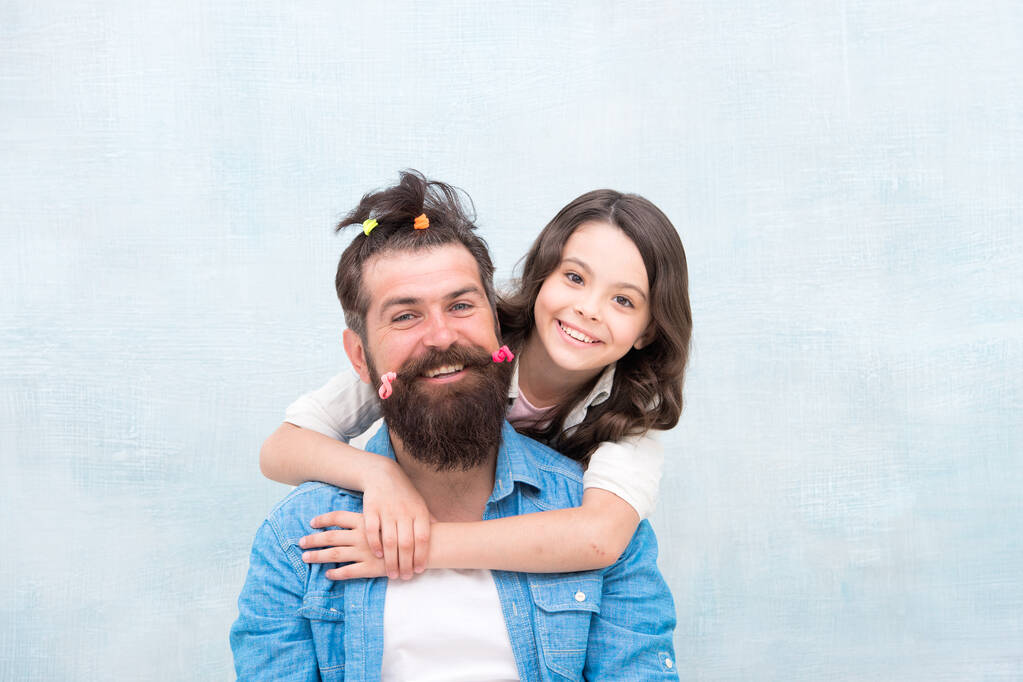 Changing the world one man at a time. Little girl hug bearded man. Small child and happy man with funny hairstyle. Caucasian man and cute daughter. Family barbershop that cares about you - Photo, Image