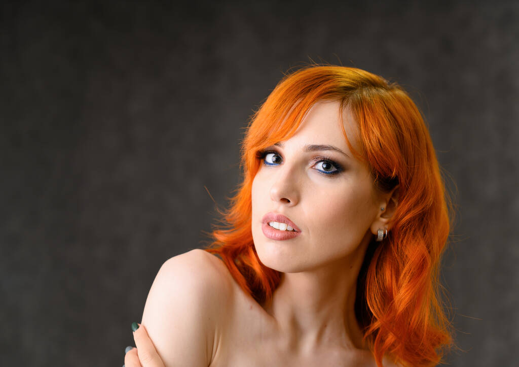 クローズアップグレーを基調としたメイクと明るい巻き毛の赤髪の可愛い女の子の肖像。美容コンセプト、美しい髪型や化粧品で化粧品のサンプル. - 写真・画像