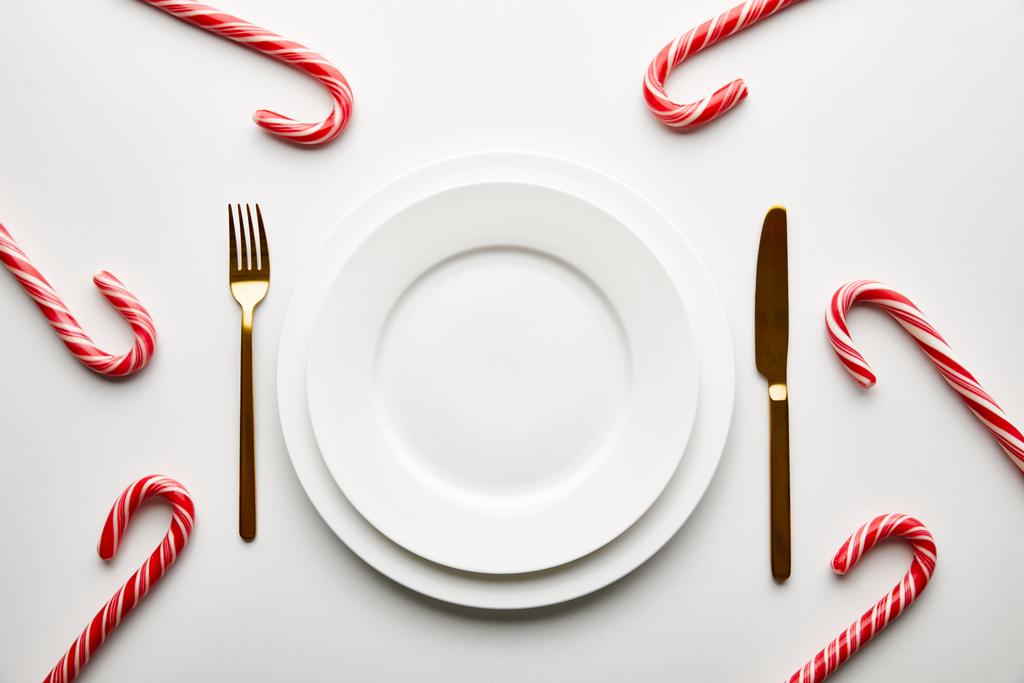 top view of festive Christmas table setting on white background with candies - Photo, Image