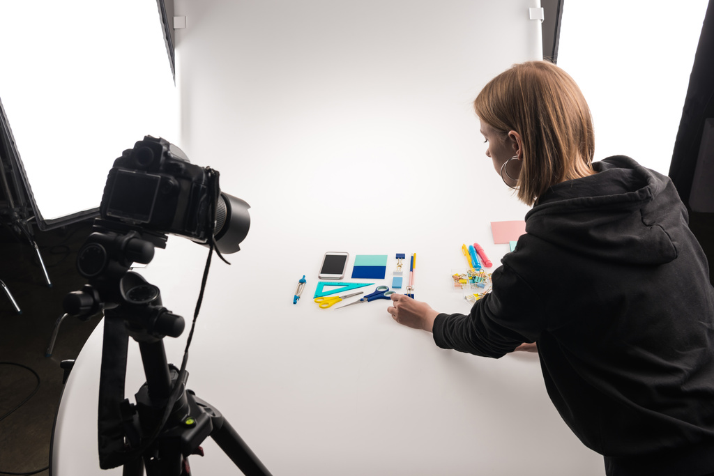 professional photographer making flat lay with office supplies for commercial photo shooting on white - Photo, Image