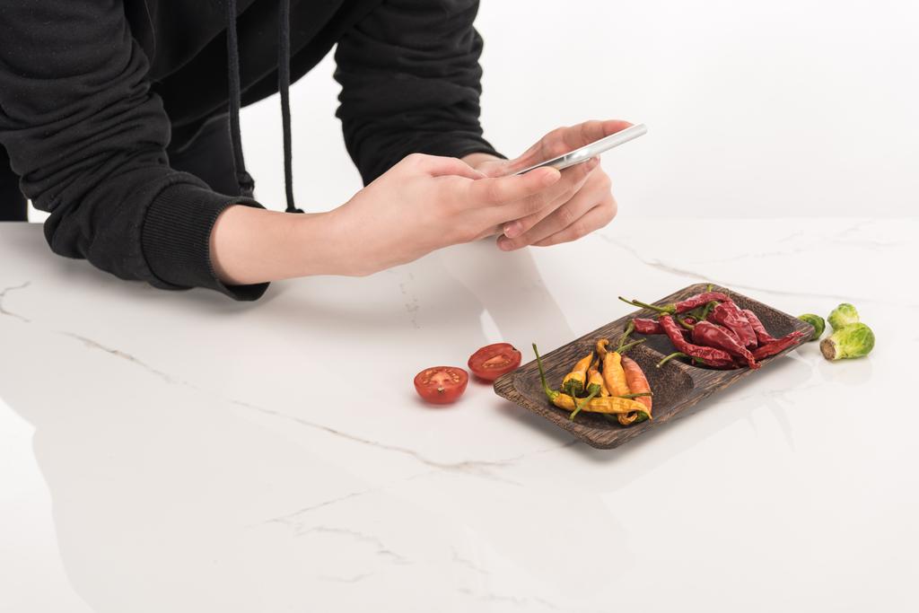 cropped view of photographer making food composition for commercial photography on smartphone - Photo, Image