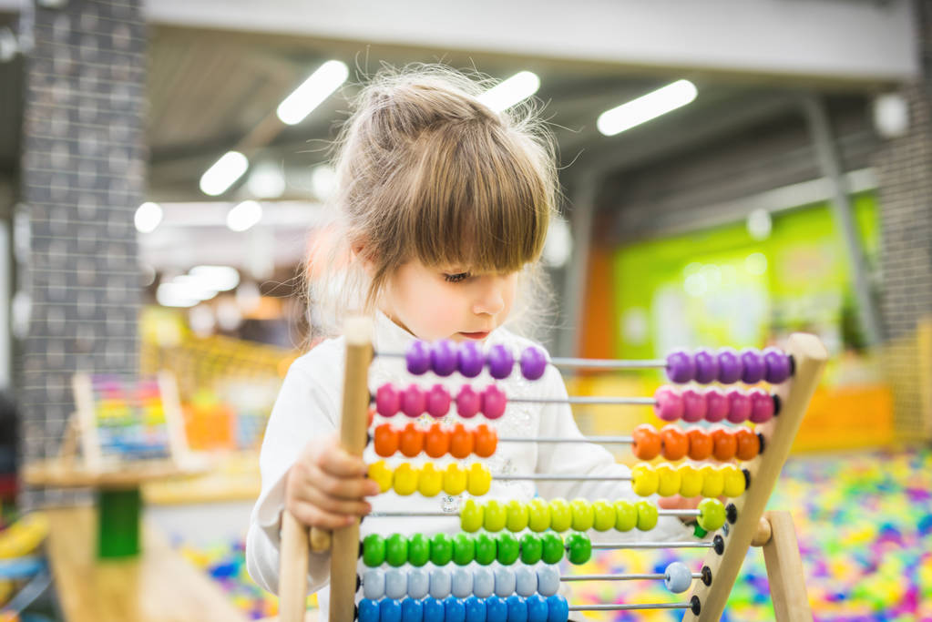 Girl playing with a wood abacus toy - Photo, Image