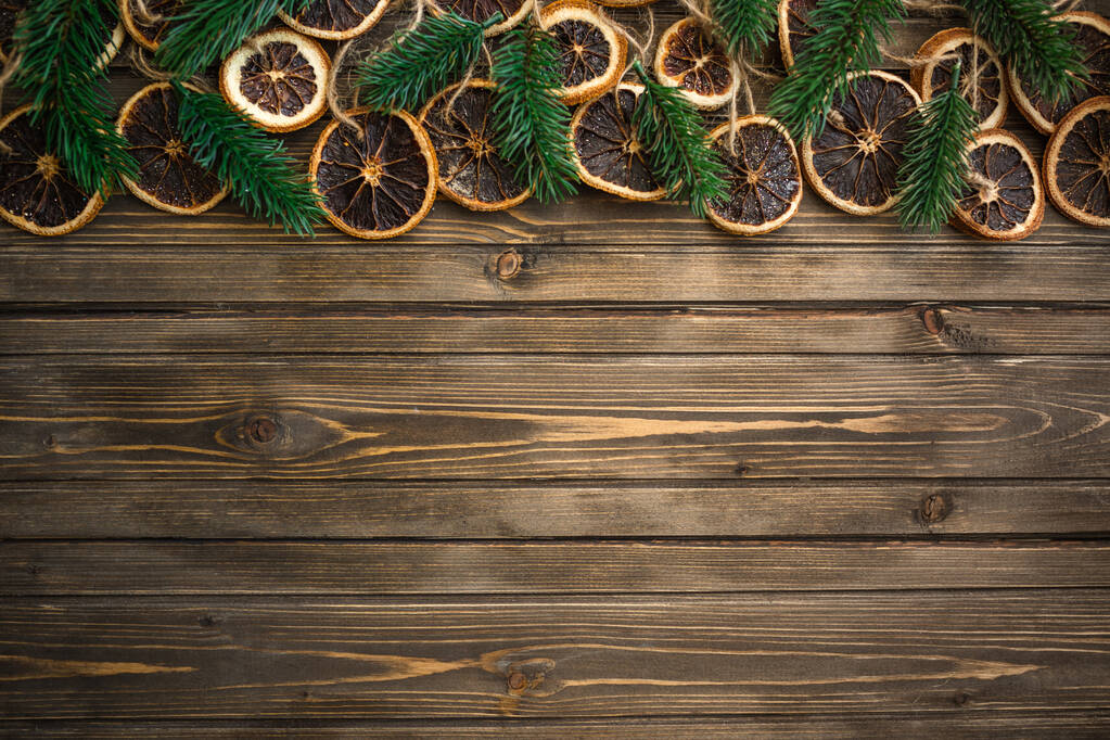 Christmas background with decorations and mandarins on wooden board. Copy space - Photo, Image