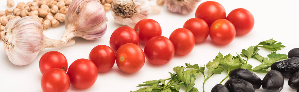 close up view of chickpea, garlic, cherry tomatoes, parsley, olives on white background, panoramic shot - Photo, Image