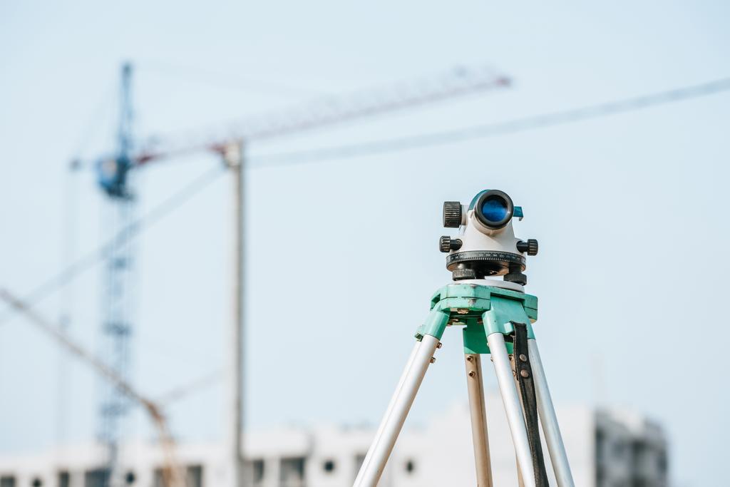Digital level on tripod with construction site on background - Photo, Image