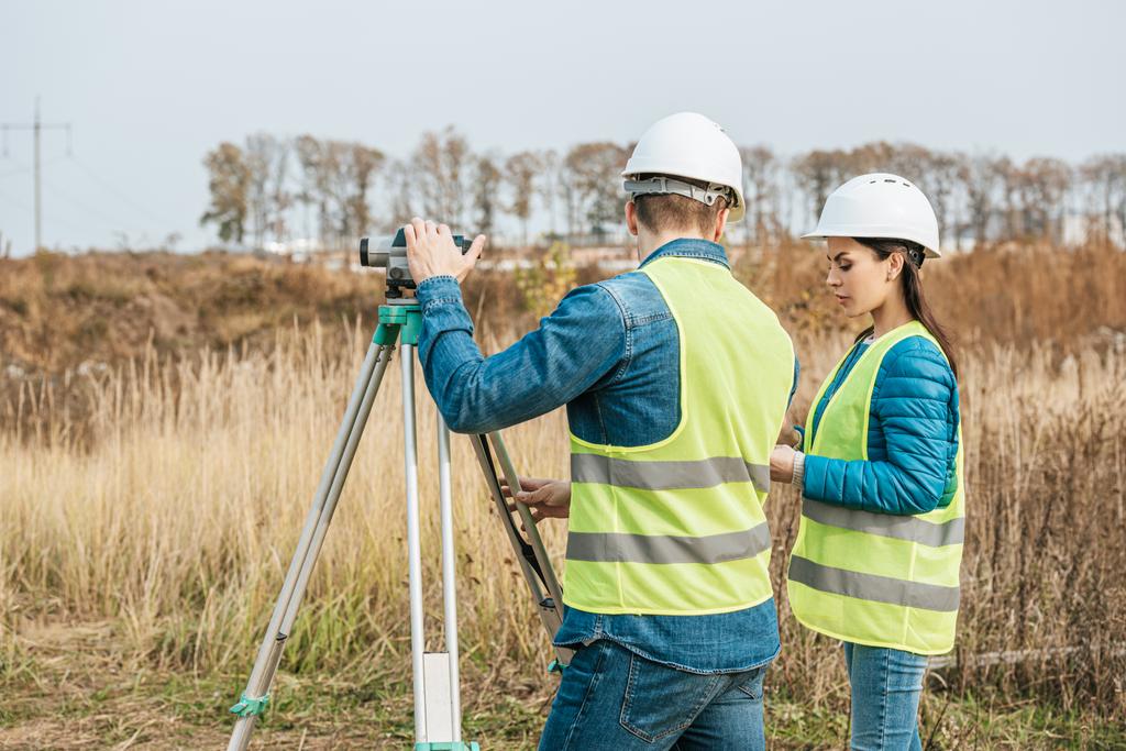 Surveyors working with digital level in field - Photo, Image