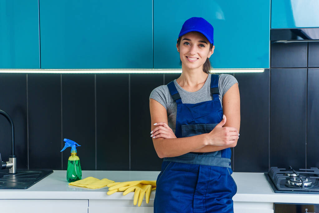 Portrait of young pretty woman in special uniform of professional cleaning service. - Photo, Image