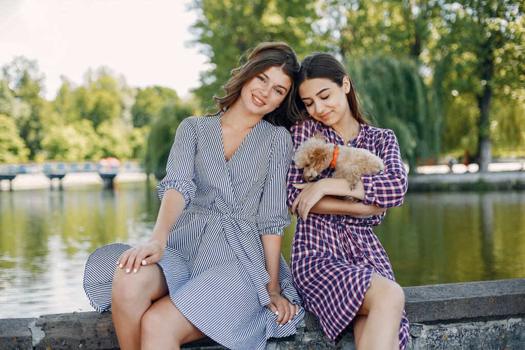 Elegant and stylish girls in a spring park - Photo, Image