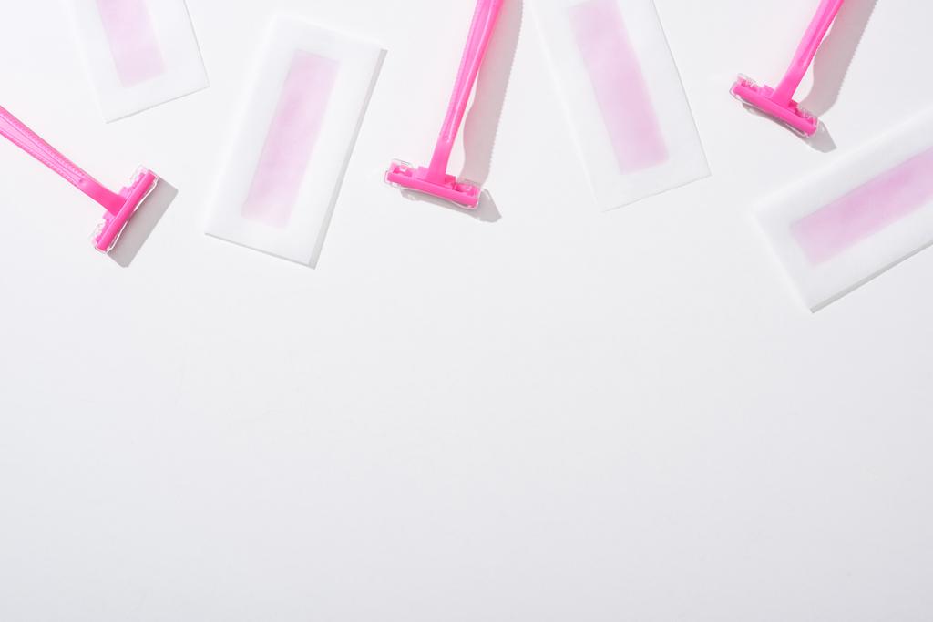 top view of pink razors and depilation wax stripes on white background - Photo, Image